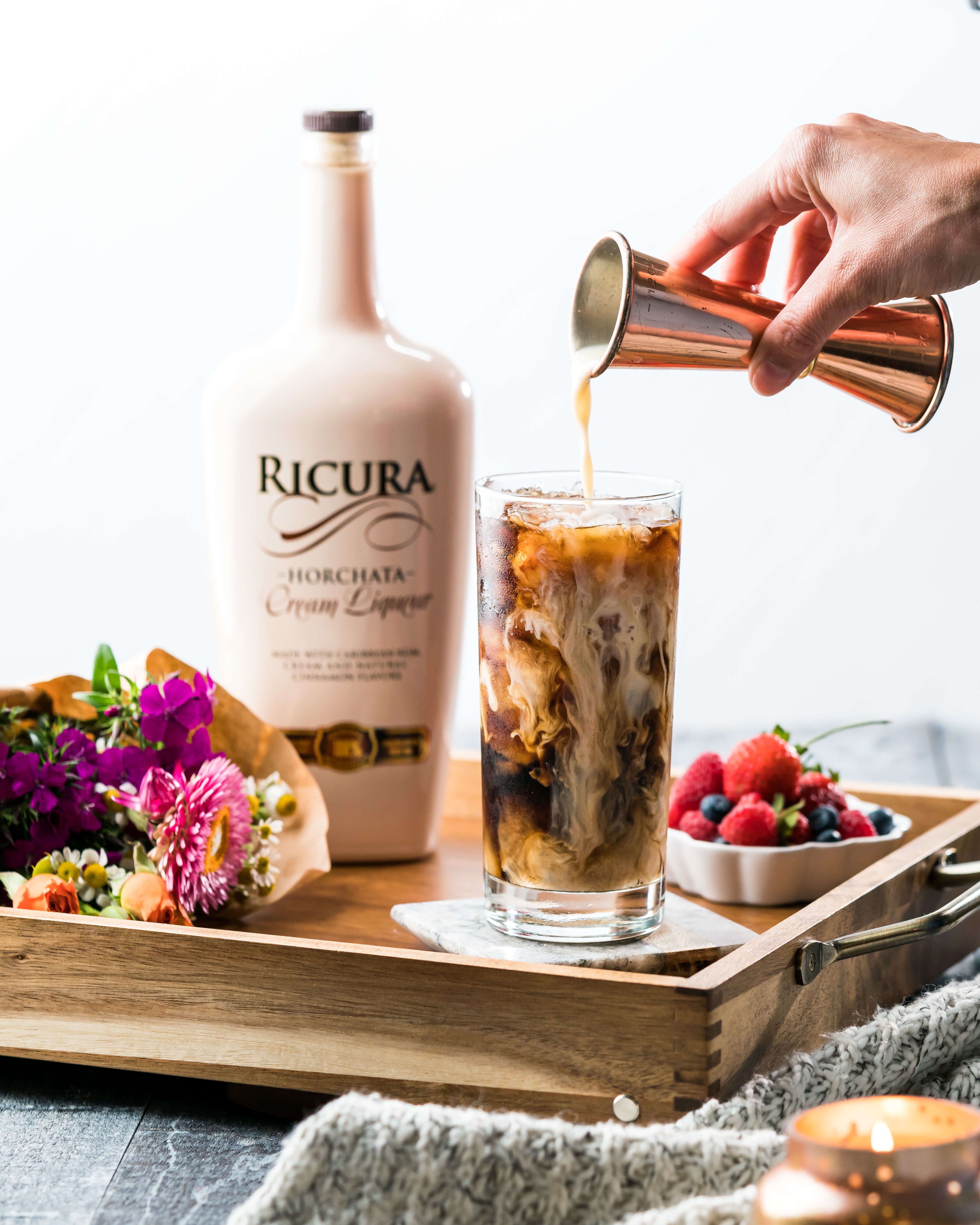Ricura Iced coffee Drink with Ricura bottle behind it