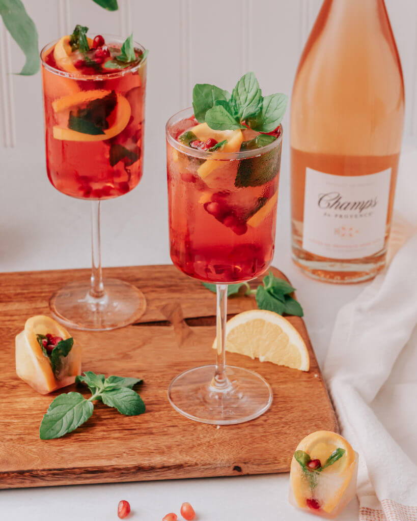 Champs - Pom Spritz decorated with fruits like lemon and pomegranate
