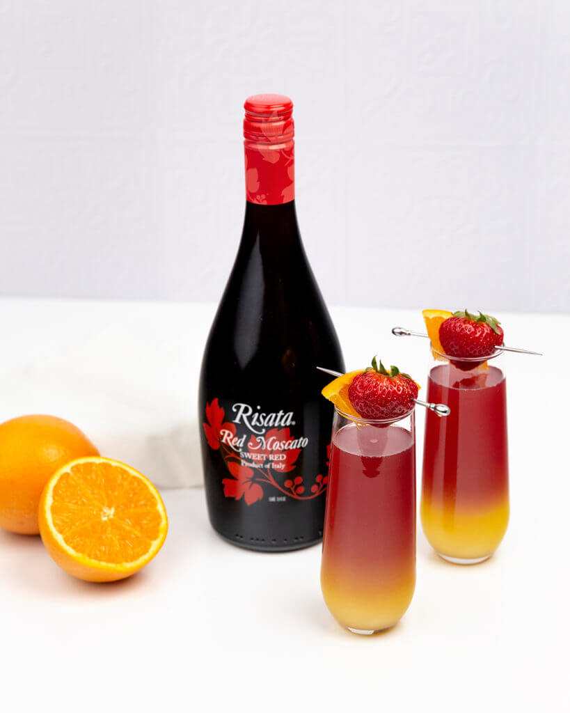 Risata Sunrise Mimosa with a red Moscato Bottle
