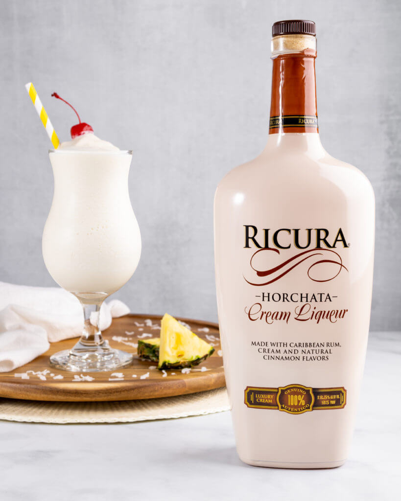 Ricura Pina Colada cocktail with a horchata bottle