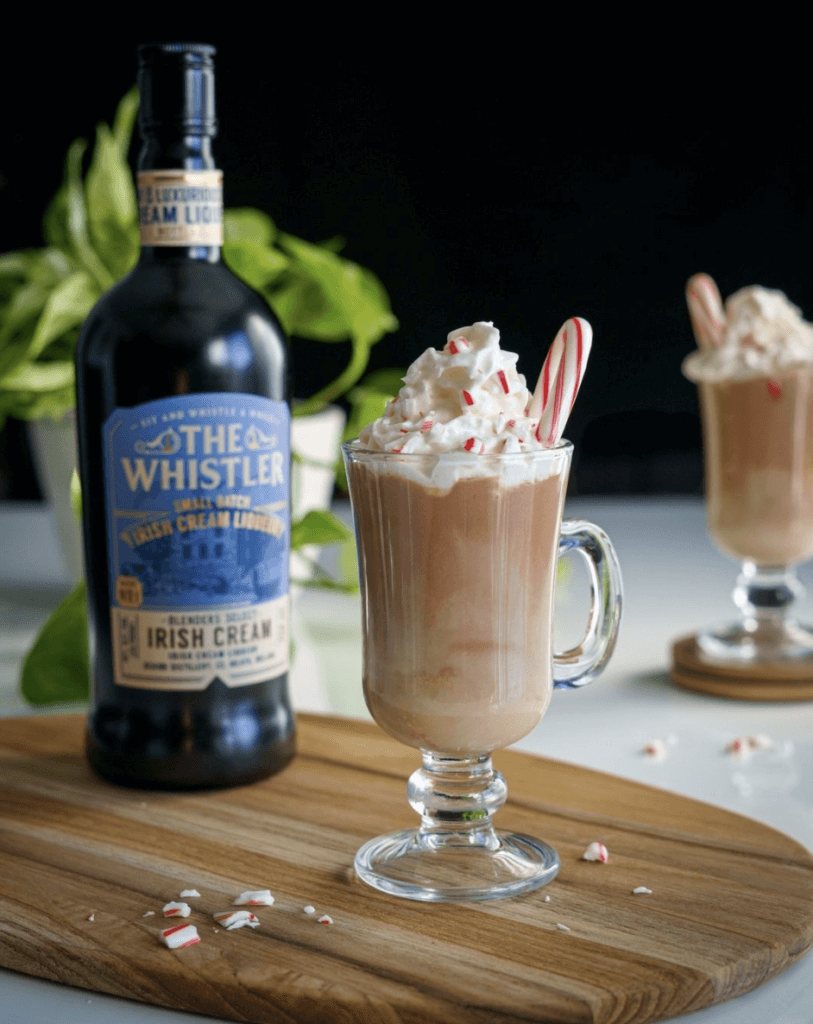 The Whistler Irish Cream with a drink beside it decorated with candies and cream
